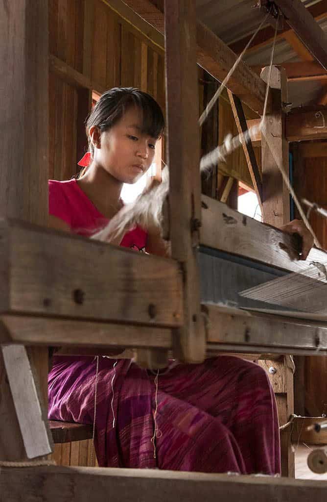 a woman is working in the lotus weaving factory in myanma burma