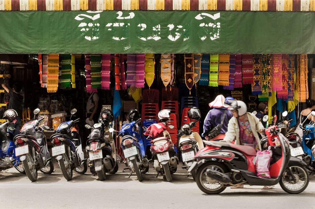 a row of colorful motorbikes in Thailand