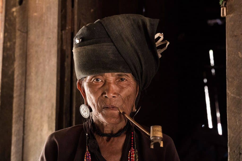 Woman from a local tribe with a long pipe