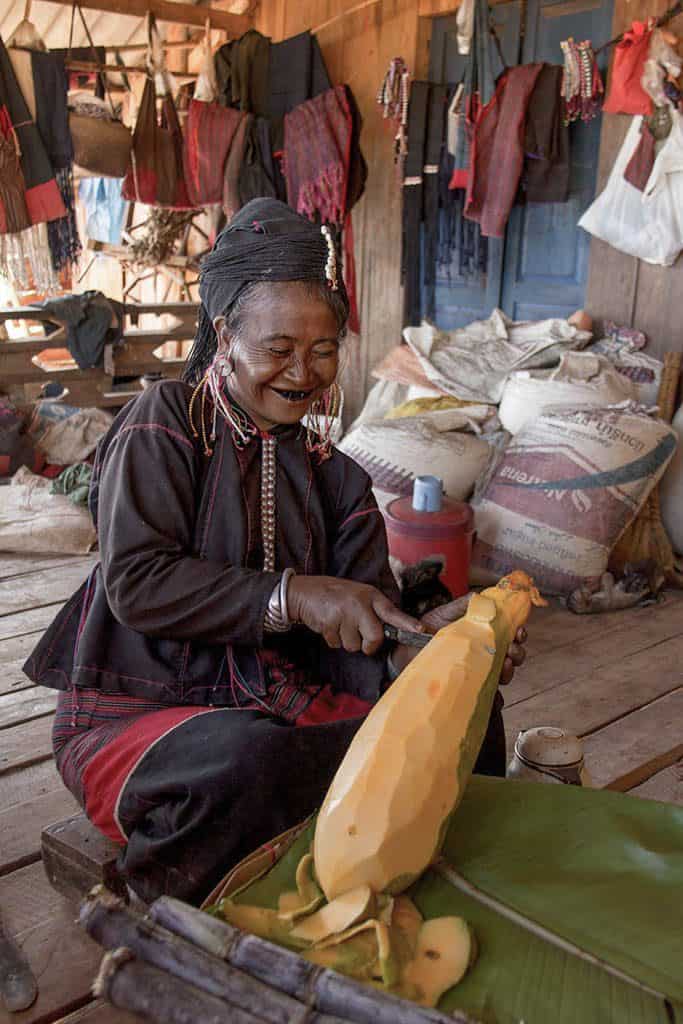 a woman piling papaya in myanmar