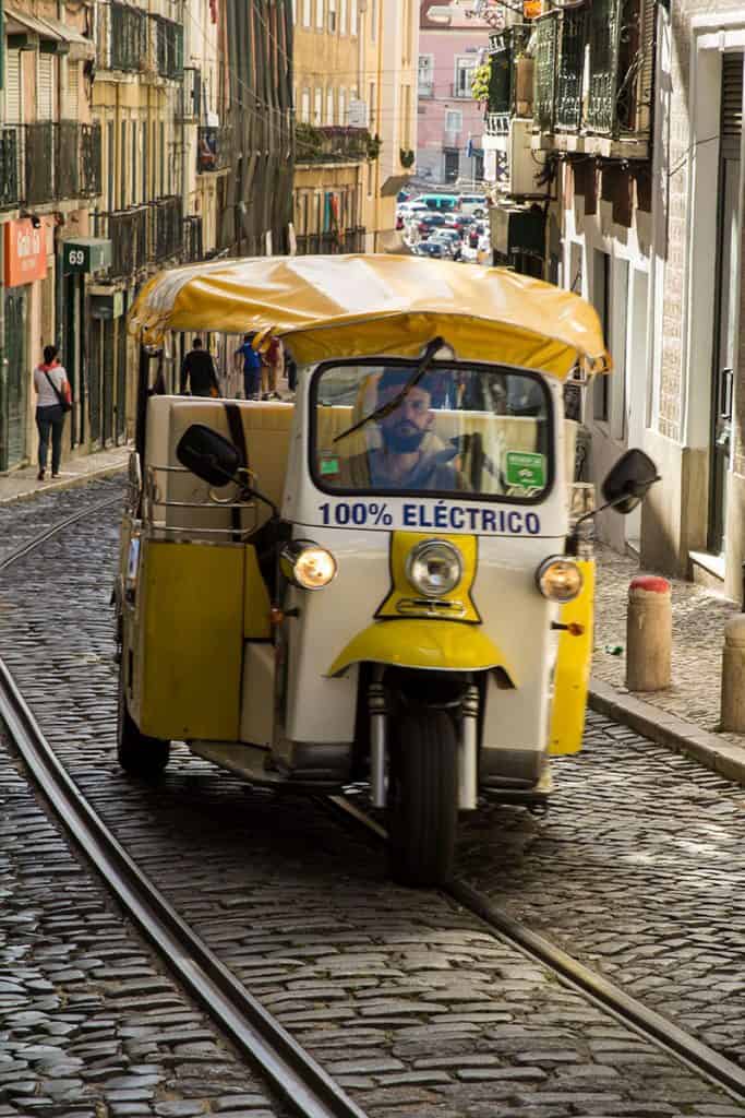 Yellow three-wheeler in Lisbon