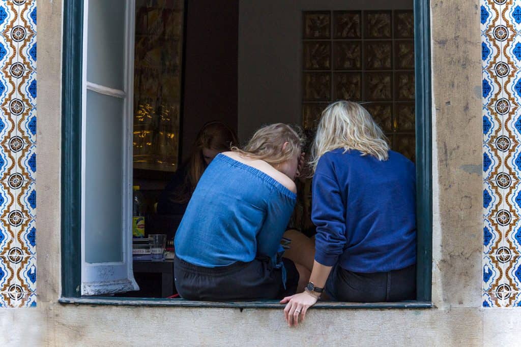 two women sitting on the porch