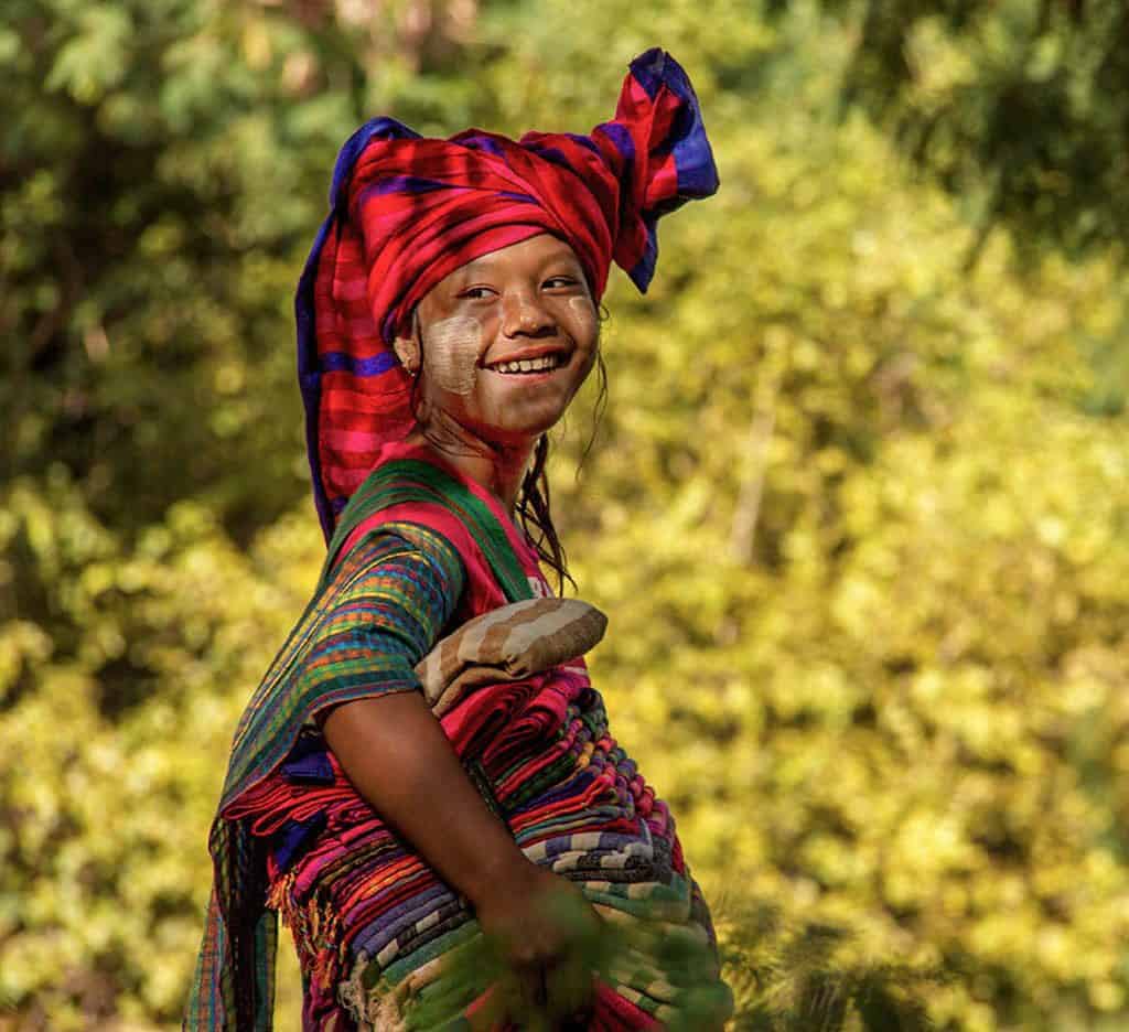 smiling girl trying to sell traditional garmets