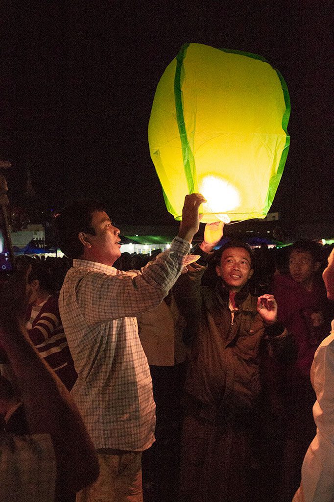men trying to fly a camdle-lit sky lantern