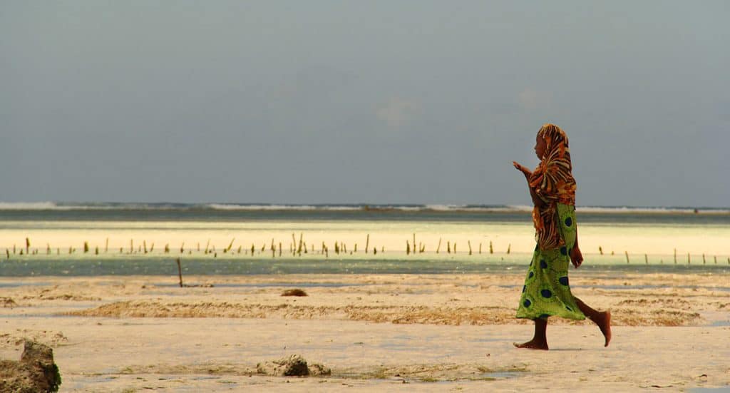 girl walking in colorful outfit on the beach