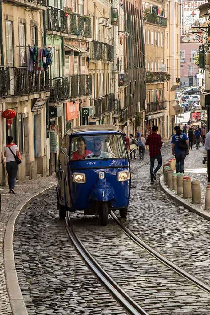 Blue tuk tuk in a cobbled street