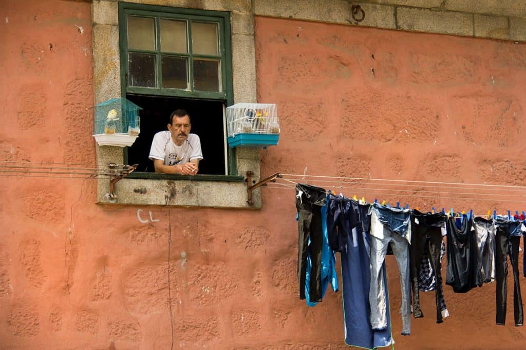 a man Look out the window in porto