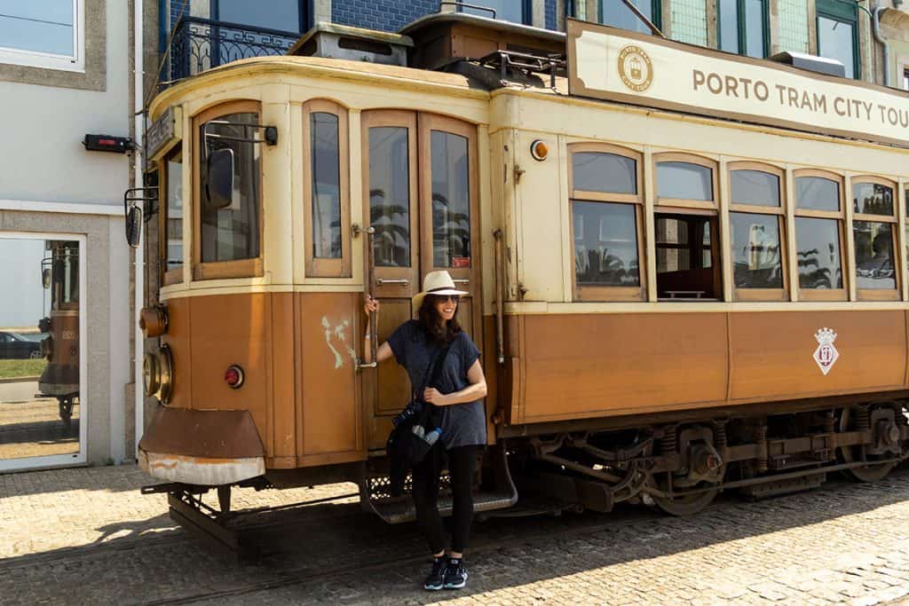 a girl next to Porto's tram