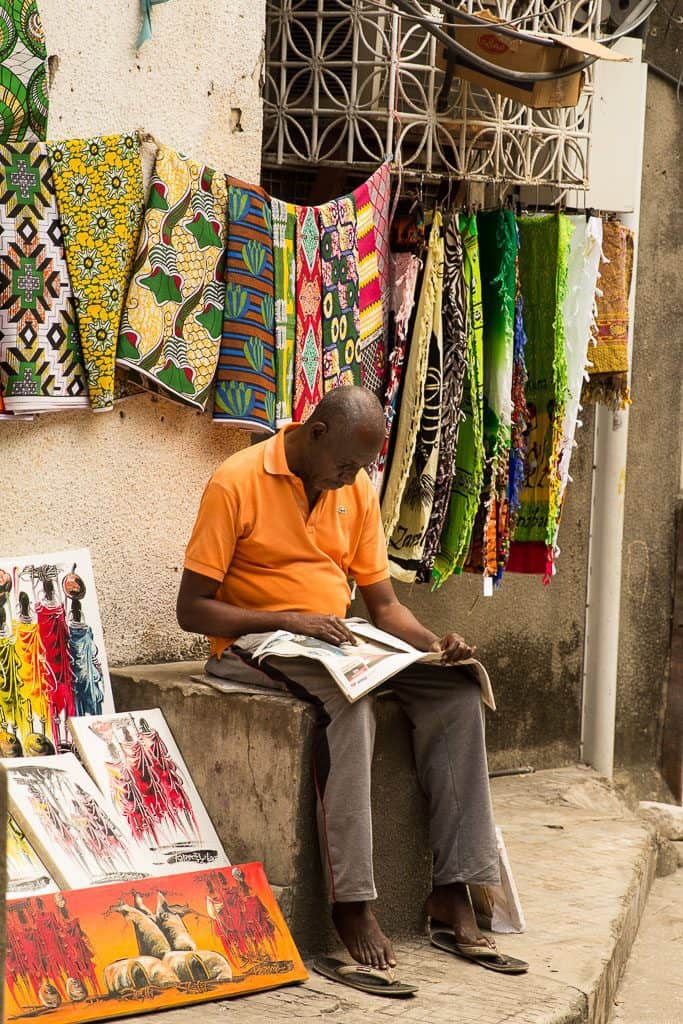A man selling colorful prints in Zanzibar