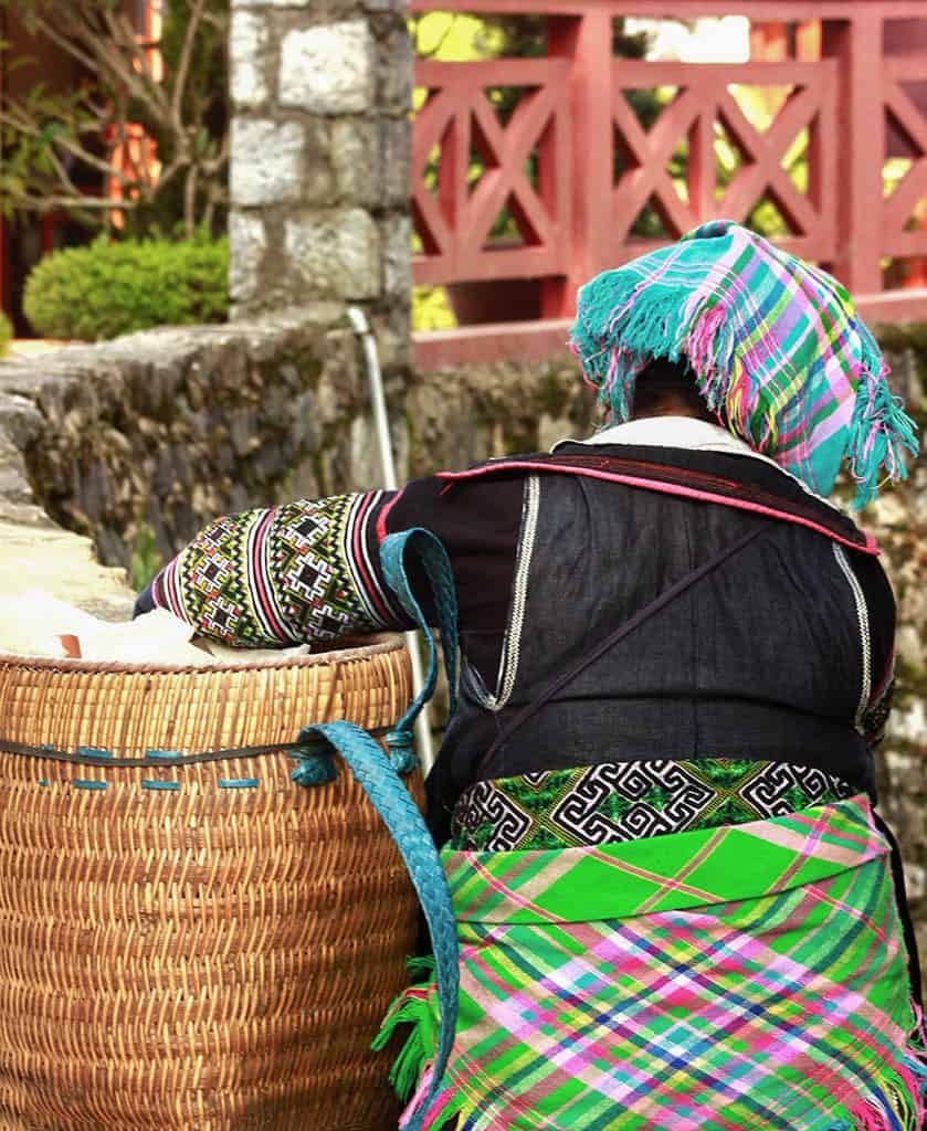 Local Sapa woman in colorful outfit - photographed from behind