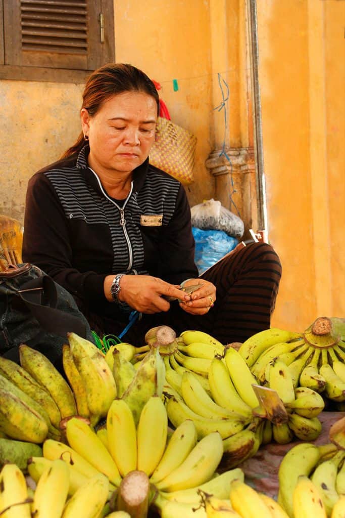 a vietnamese woman selling bananas in the market