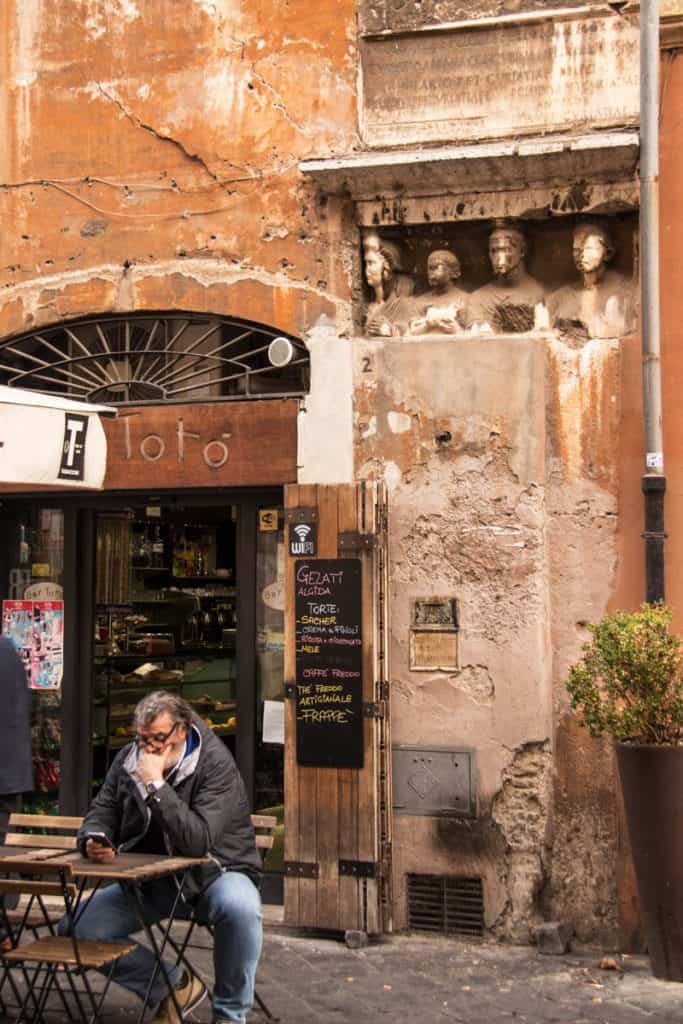 a man sitting in one of Rome's coffee shops