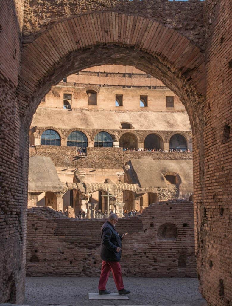 a man walking in the Colosseum in Rome