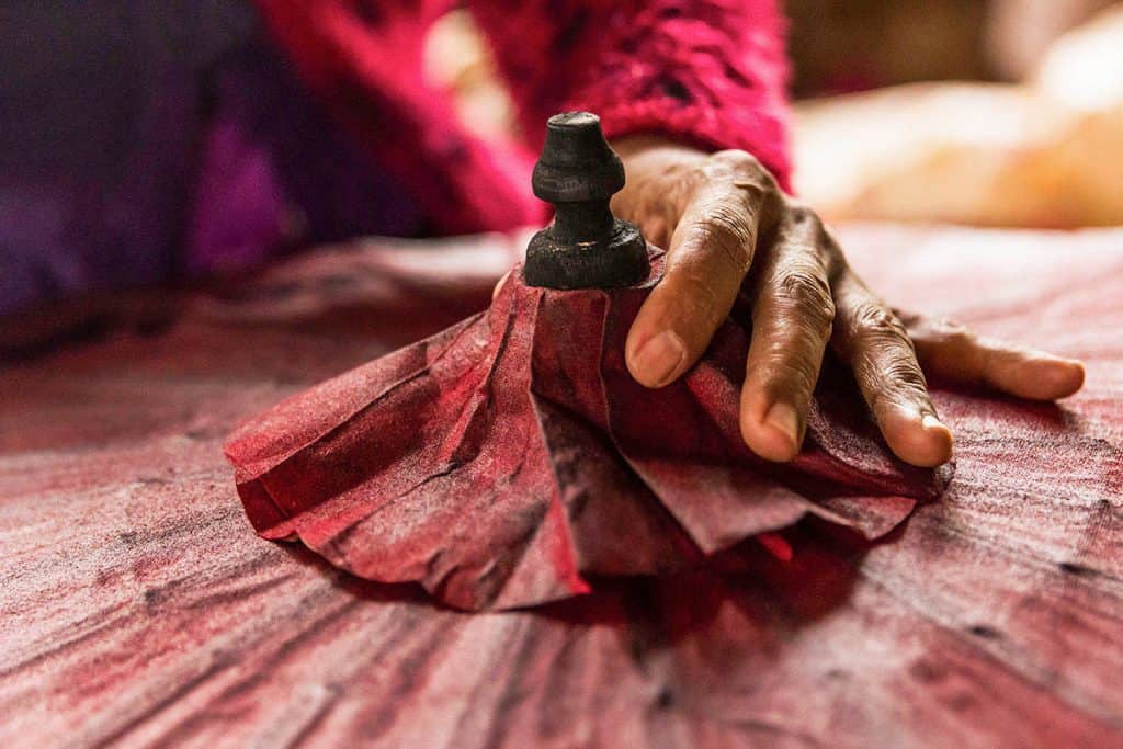 hand of a woman making a paper umbrella