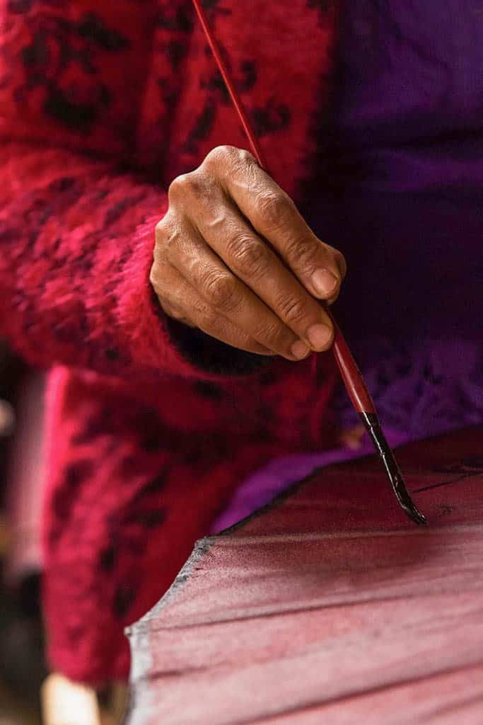 decorating a paper umbrella in pindaya myanmar