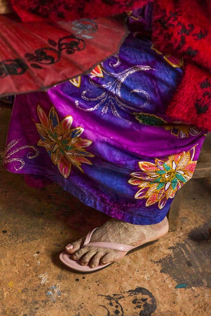 foot covered in thanaka and colorful longyi