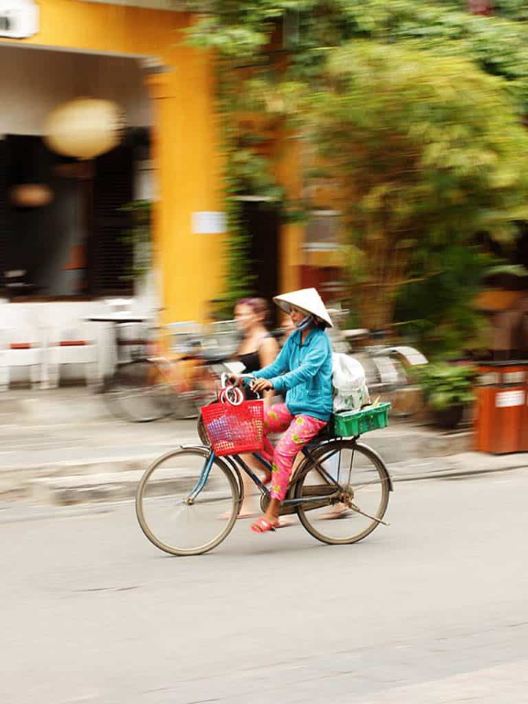 Vietnamese woman on bicycle (blurry background)