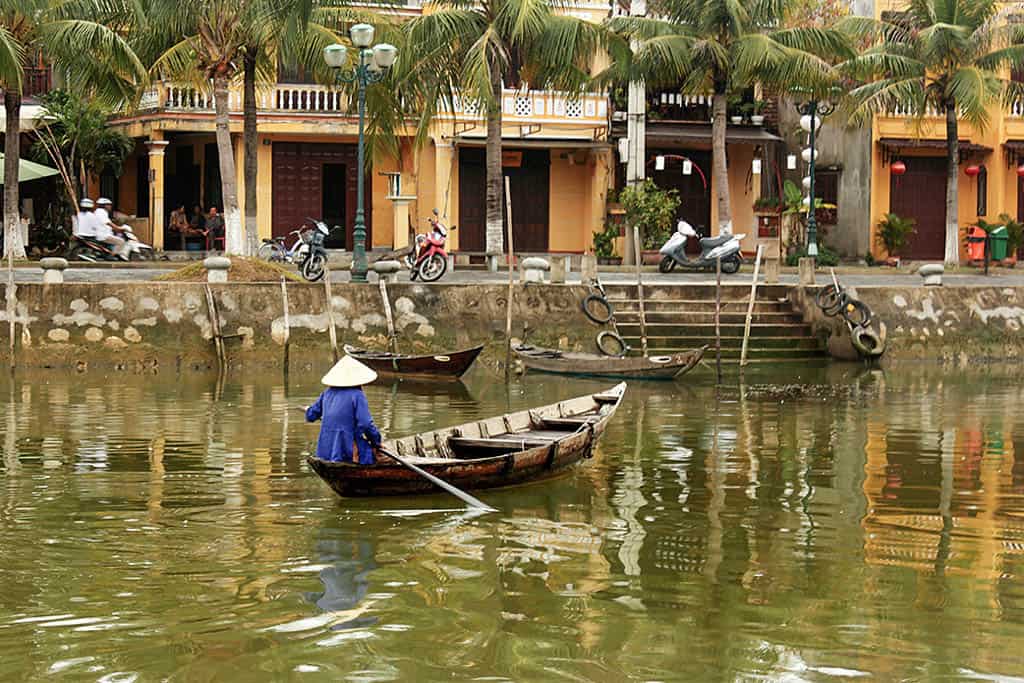 man in a boat crossing Hoi An's river