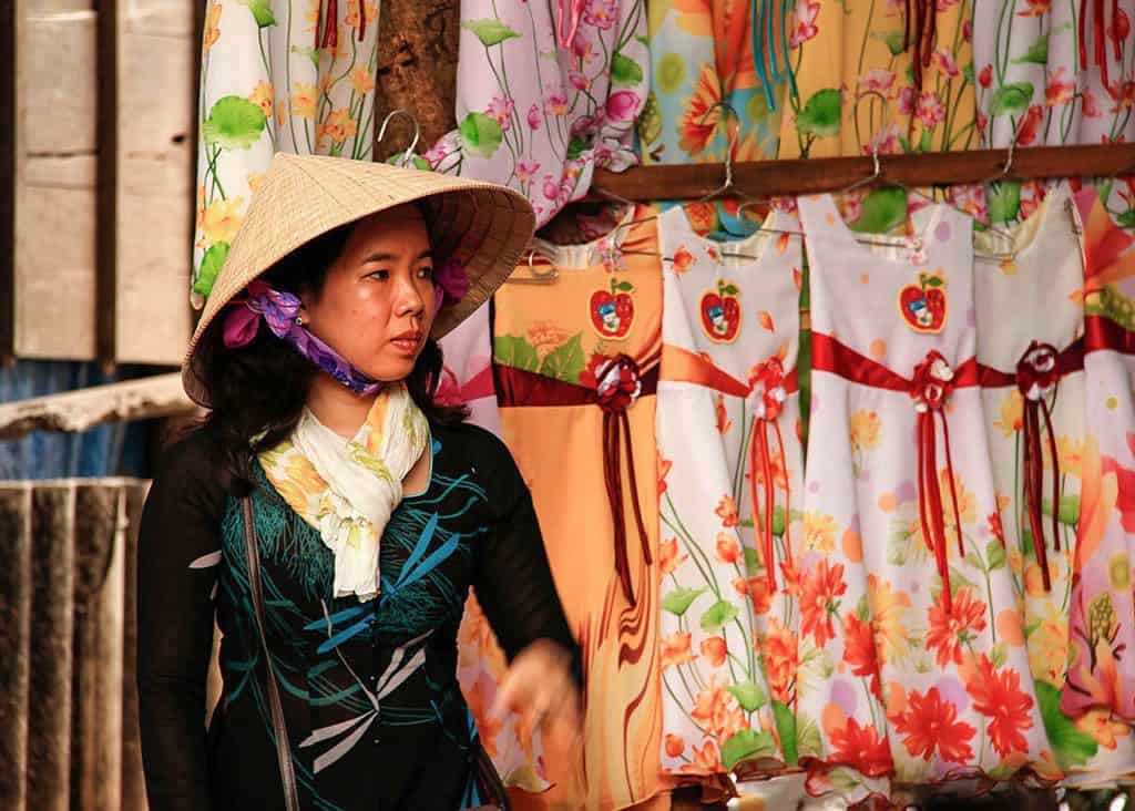 woman and behind her rows of dresses Vietnam