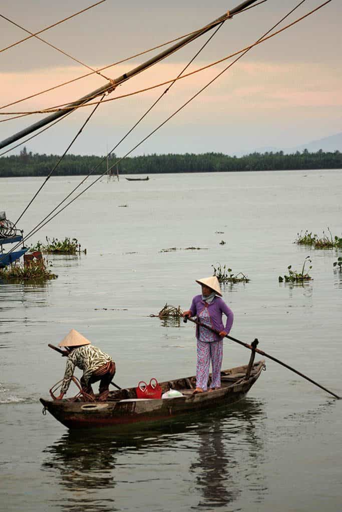two Vietnamese women fishing in a boat