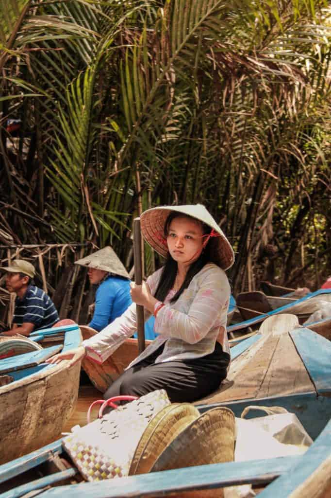 A Vietnamese woman rowing a boay