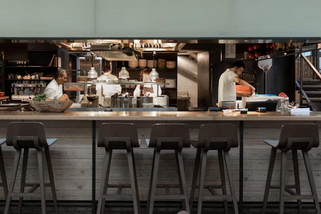 chefs cooking in a restaurant bar