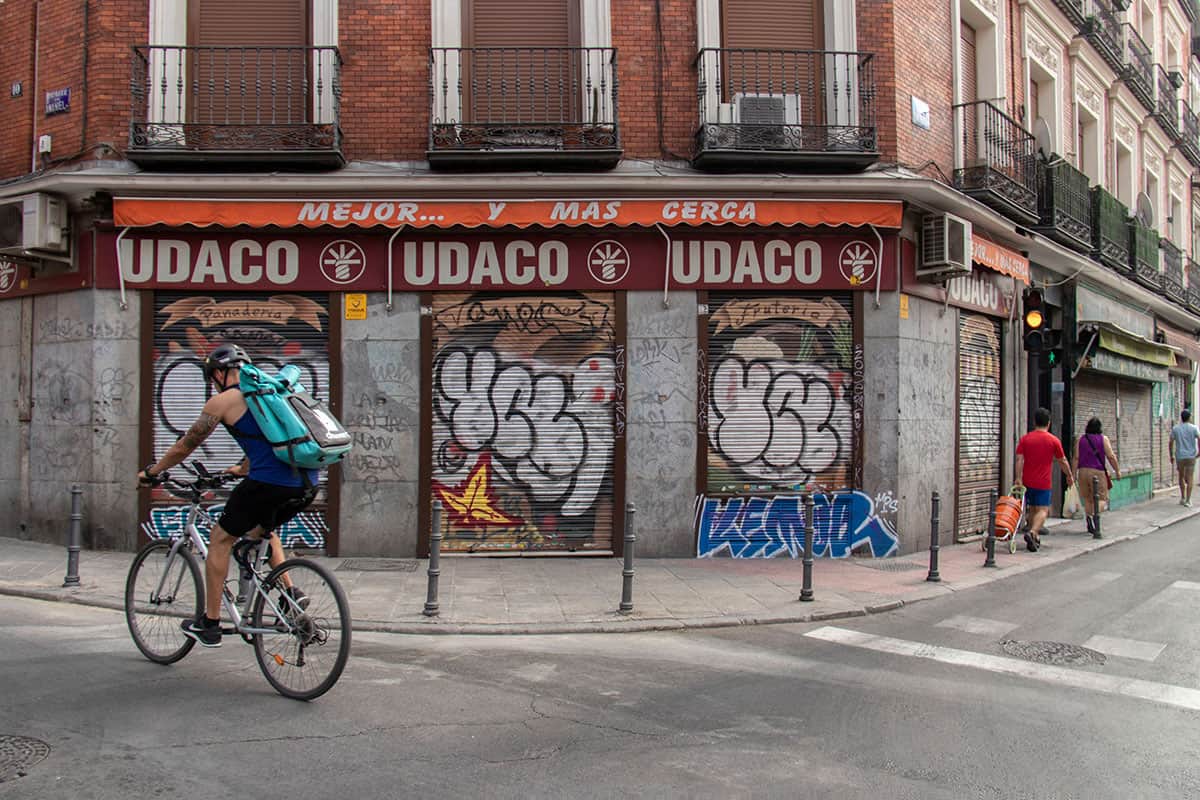 a man riding his bicycle in chueca madrid