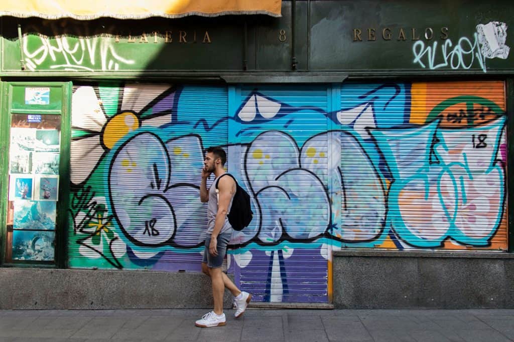 a man walking through a colorful graffiti