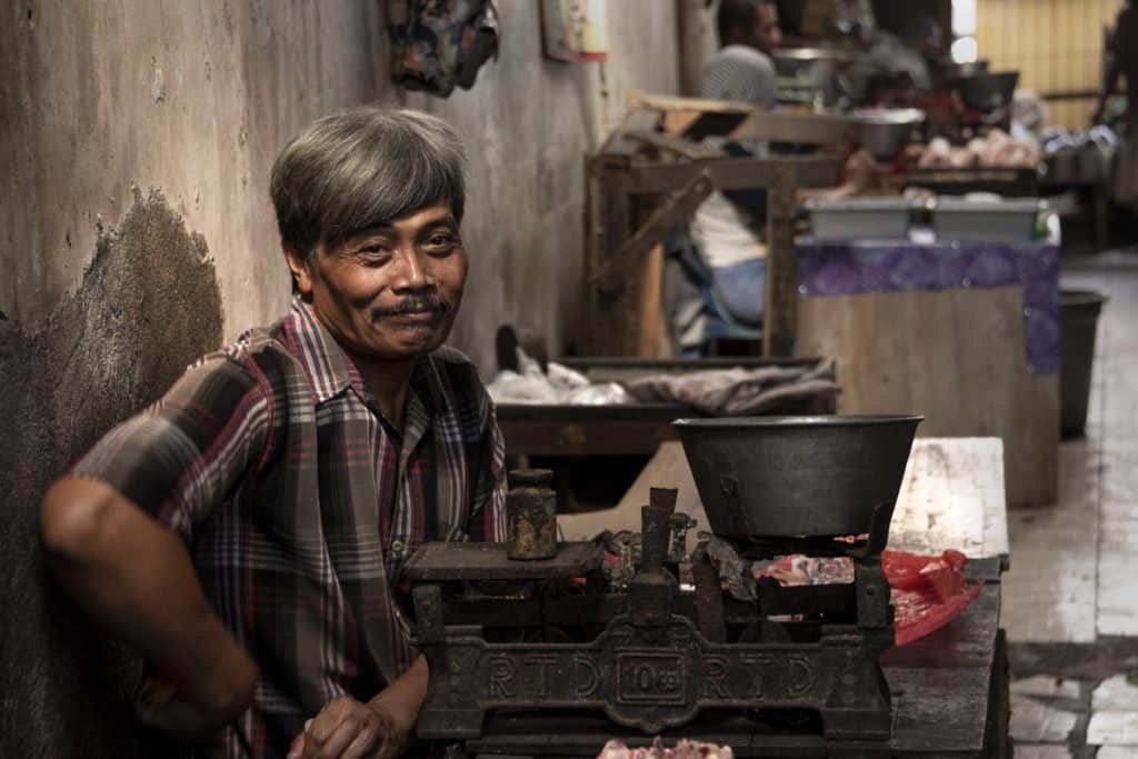 a smiling vendor in the market