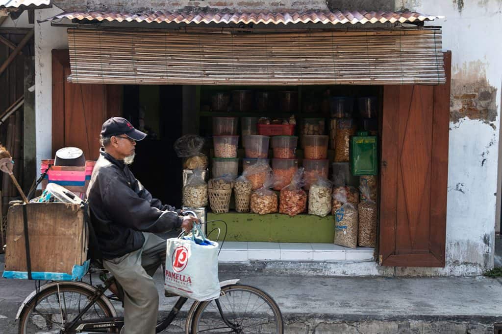 a local riding his bicycle in jogyakarta streets