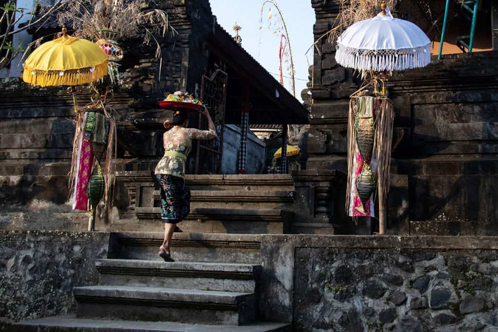 a women walking to a temple in bali