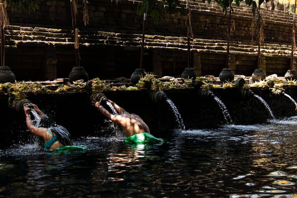 a couple taking a dip in the holy water temple