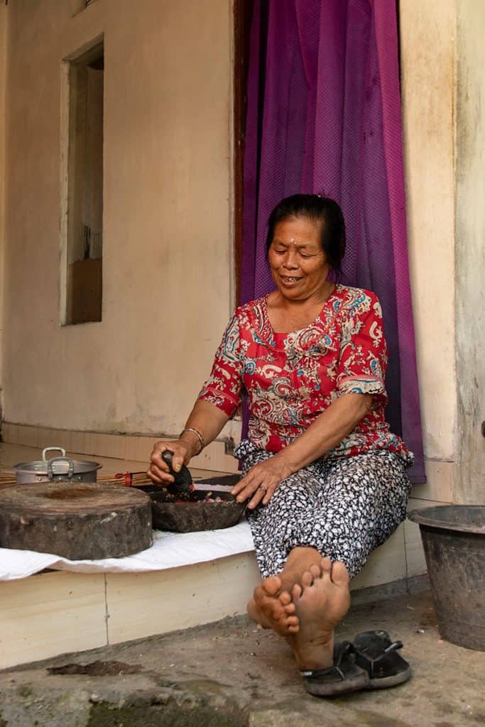 local Balinese woman making Indonesian sambal