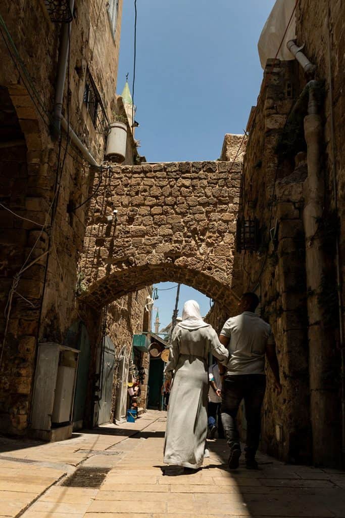 a couple walking in Acre alleys