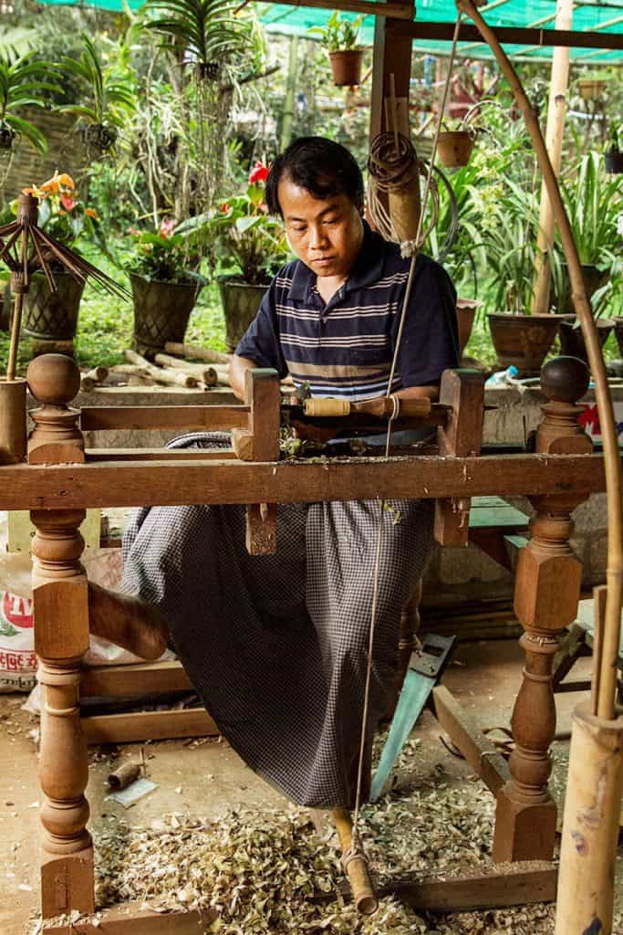 a local man working in a factory for paper umbrellas in pindaya