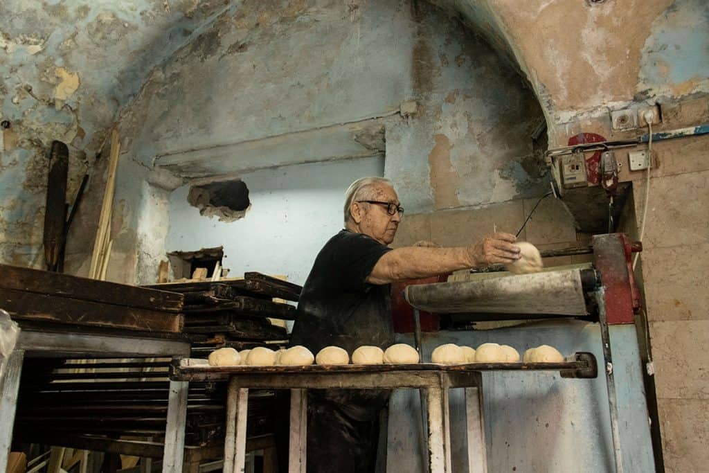 a baker preparing pita bread
