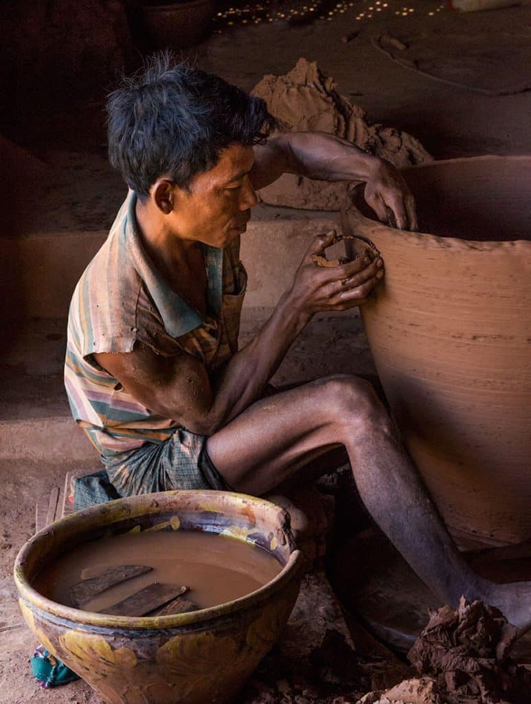 a man working in terracotta pots factory in Myanmar