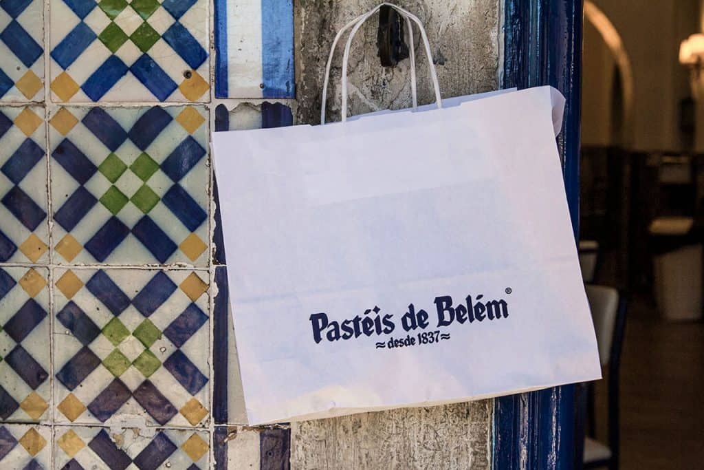 a paper bag with pasteis de nata in Lisbon