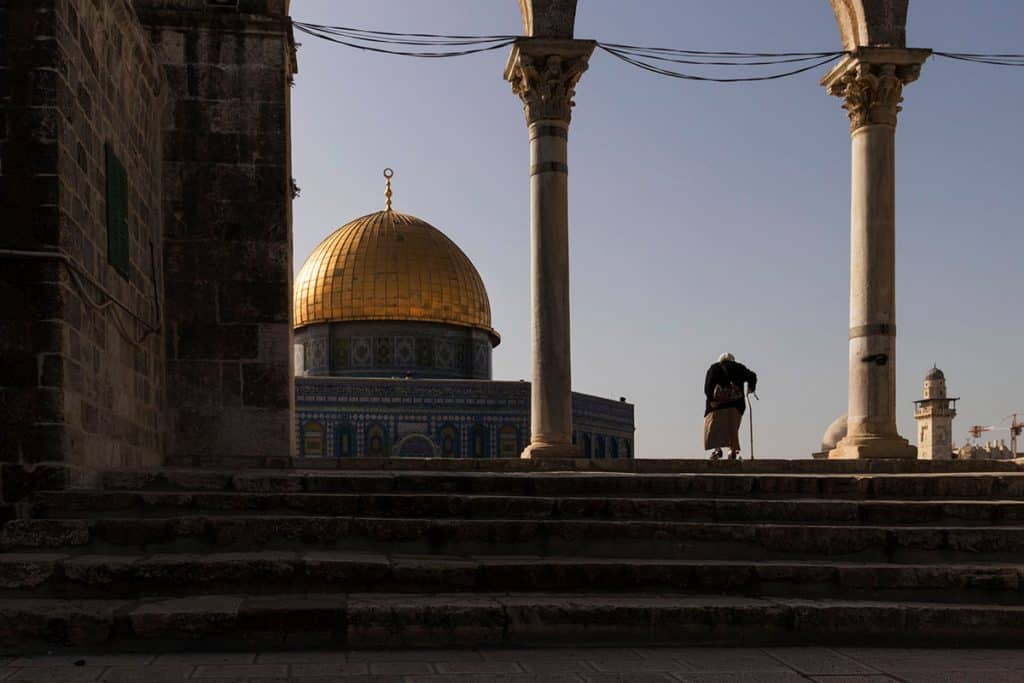 An elderly woman visitng the Dome of the Rock in Jerusalem