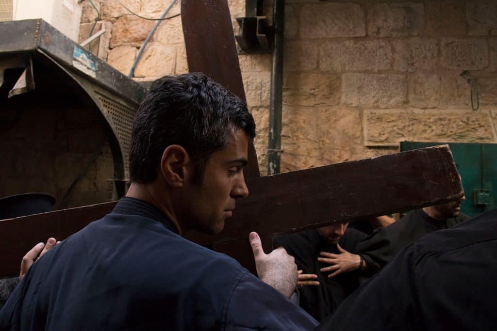 Man carrying a huge cross during Good Friday in Jerusalem