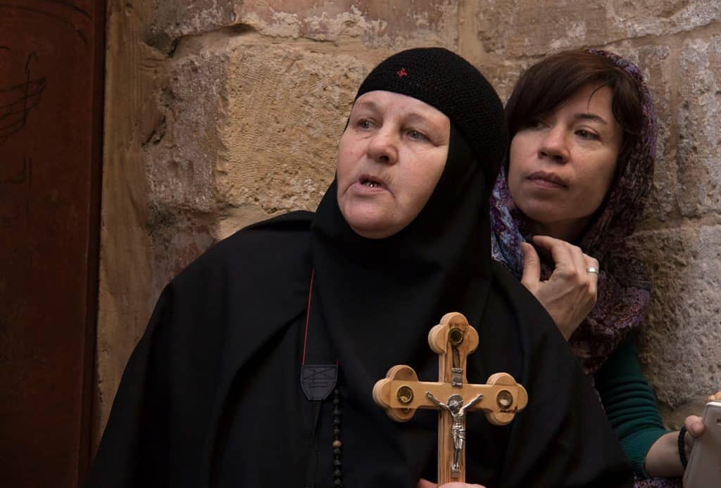 Woman holding a cross at the Good Friday procession in Jerusalem