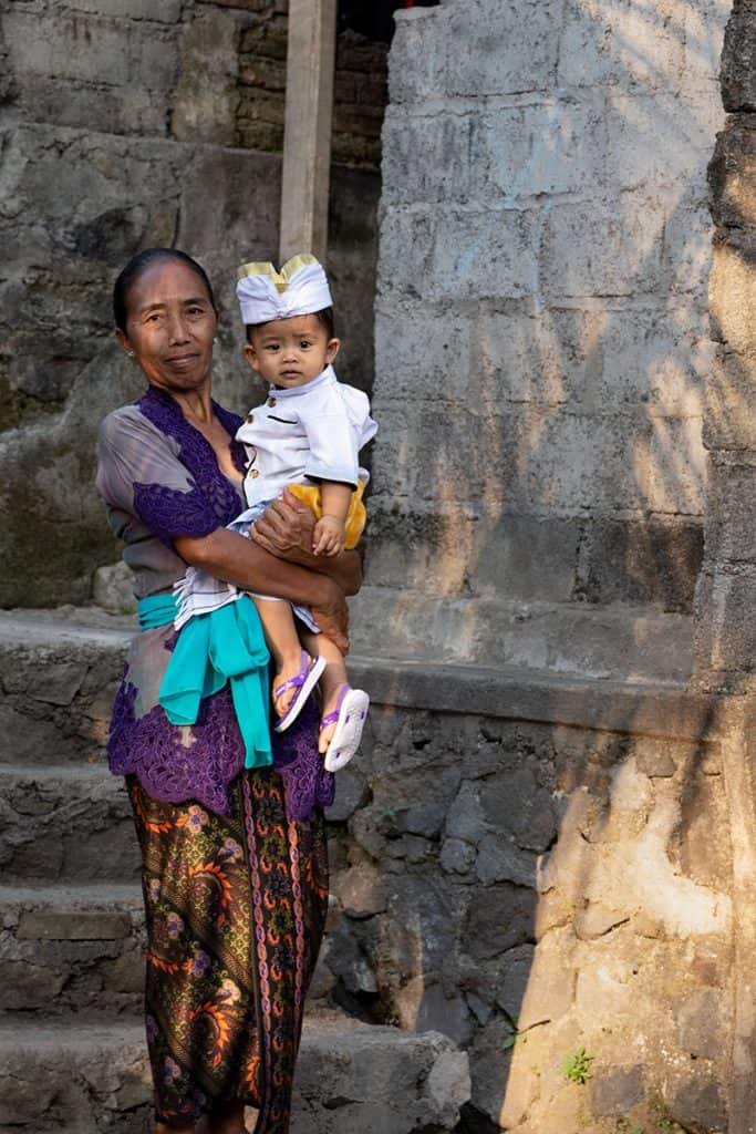 a woman holding her baby in Sidemen Bali