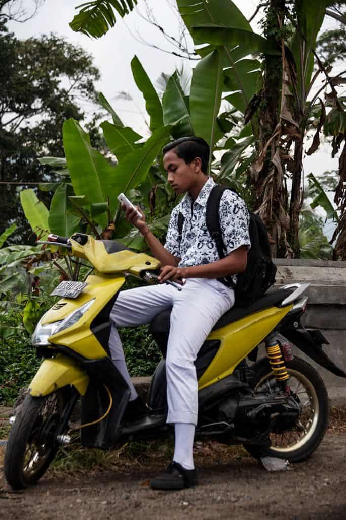 Handsome Balinese boy on a motorbike in Sidemen Bali