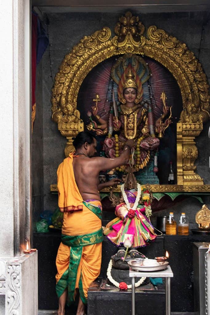 a local man is decorating the temple in Singapore