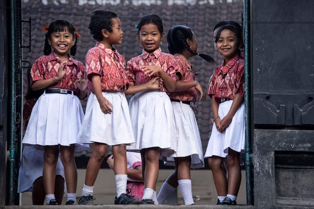 smiling girs in front of a school in Bali
