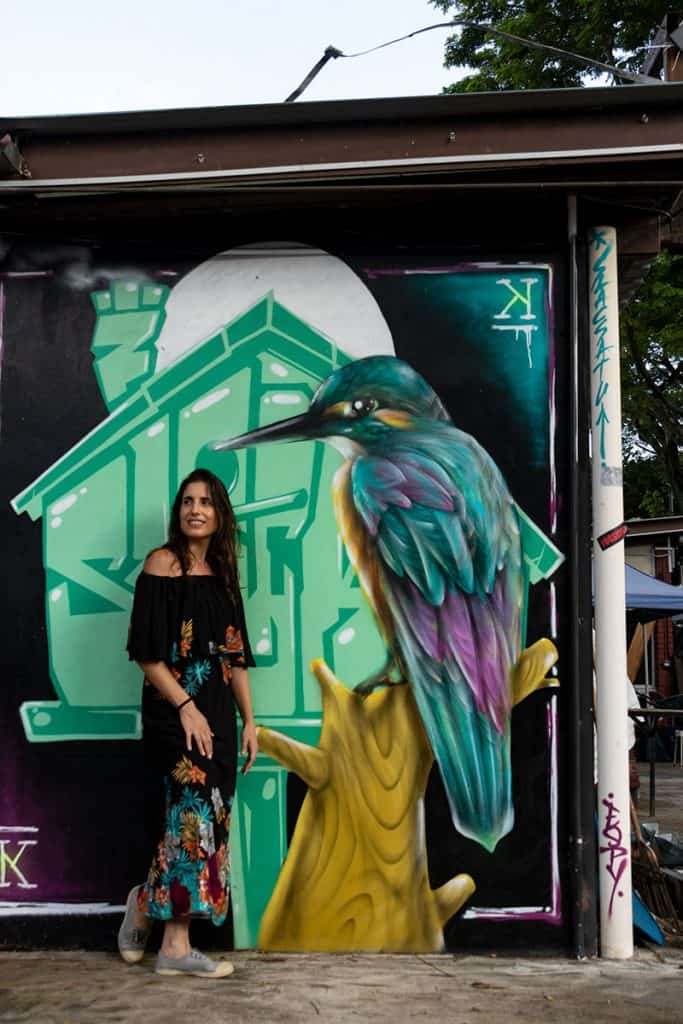 a woman modeling in front of a colorful graffiti in Singapore