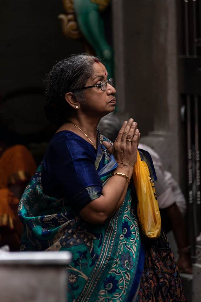 a woman praying in Singapore