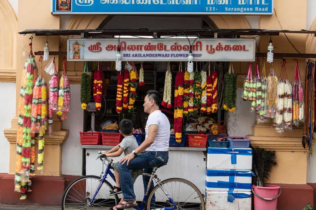 a man and a child riding on a bike in Singapore