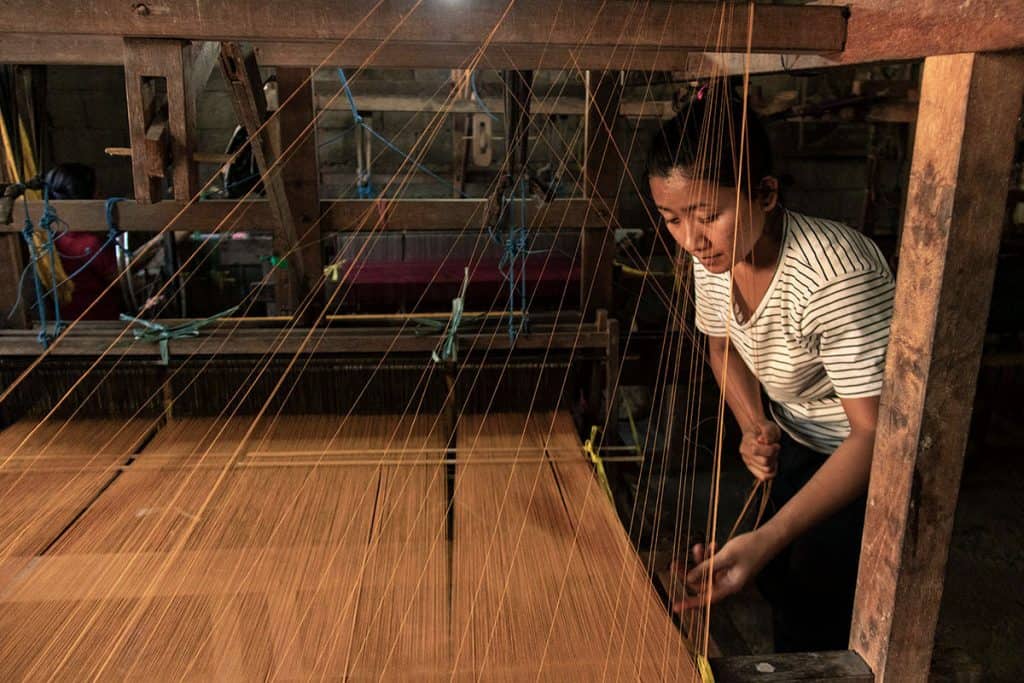 a weaving girl in one of Bali's factories