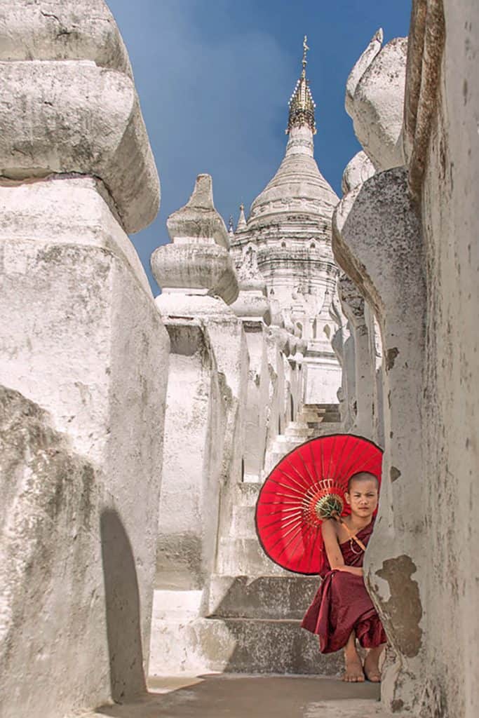 a monk sitting in a pagoda in myanmar - Mandalay Mingun